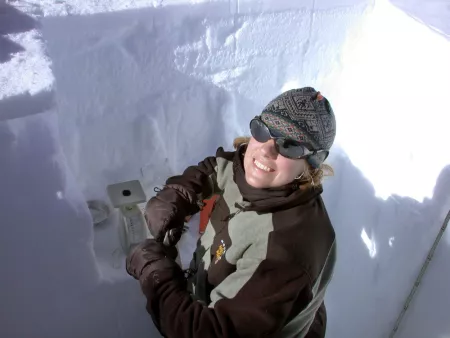 Scientist takes samples of snow in snow pit Scientist takes samples of snow in snow pit